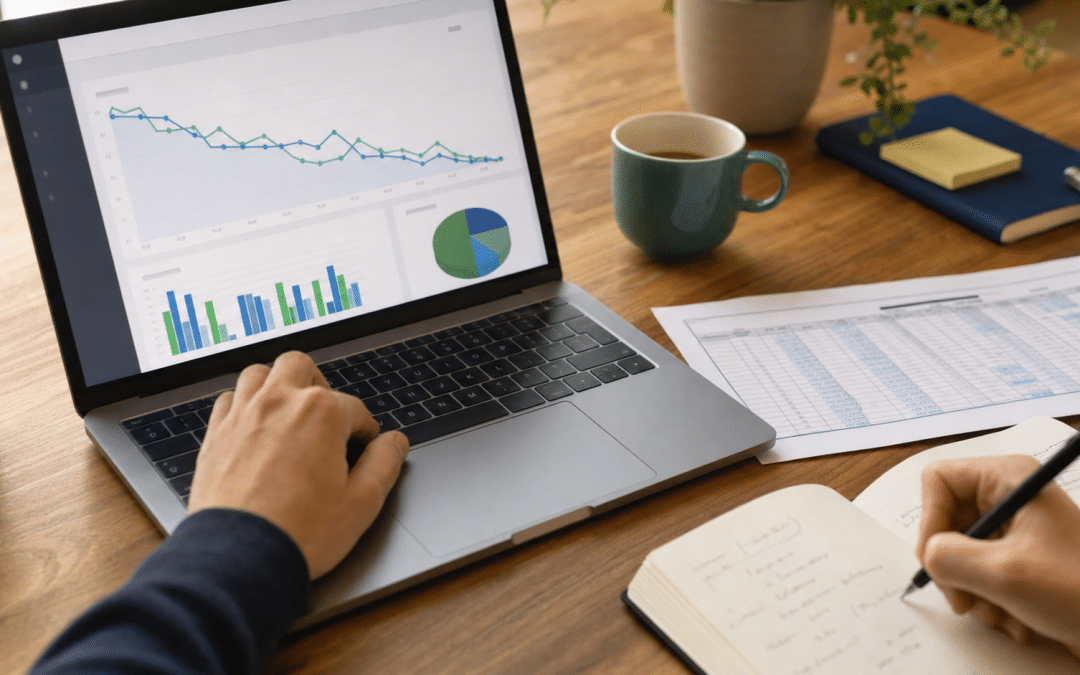 how to find declining seo pages - analyst reviewing performance graphs on laptop with printed data sheets
