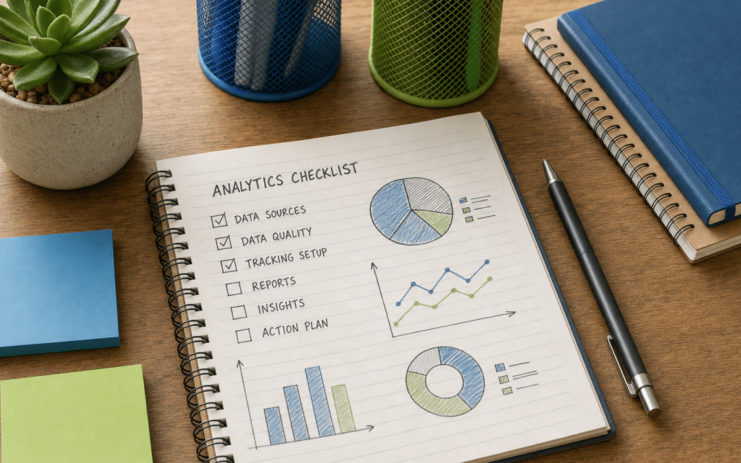 ga4 setup checklist notebook flat-lay with blue and green stationery on wood desk
