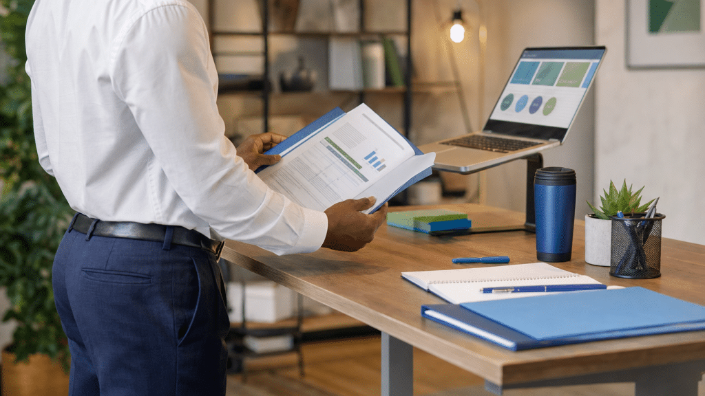 b2b buyer journey South Africa — business professional reviewing procurement brief at standing desk